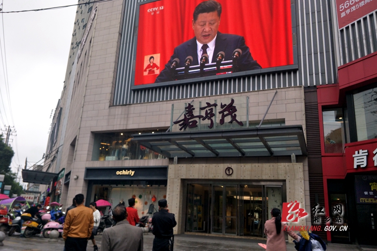 嘉亨茂购物中心的电子屏正在直播十九大实况，不少市民驻足观看.jpg